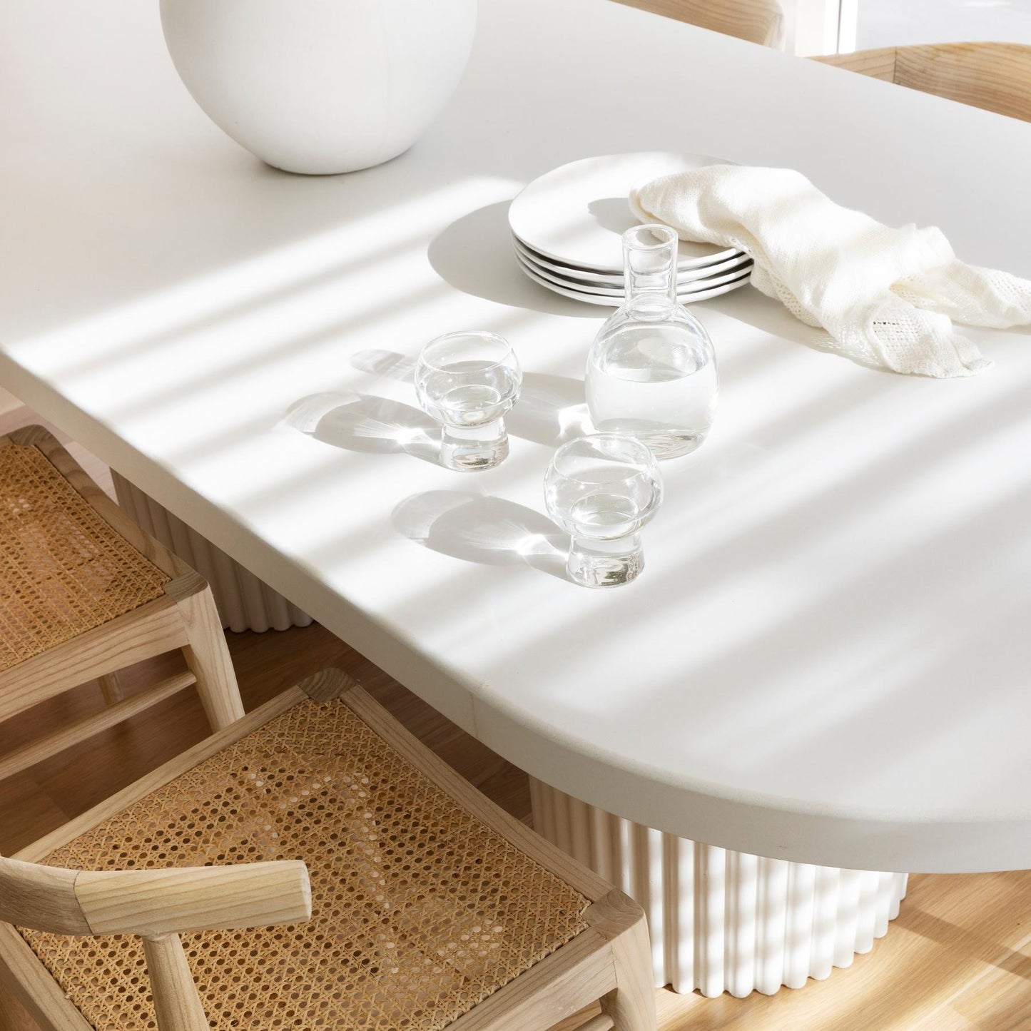 Coco and Henry clear Marnie carafe and stemless wine glass filled with water on white table
