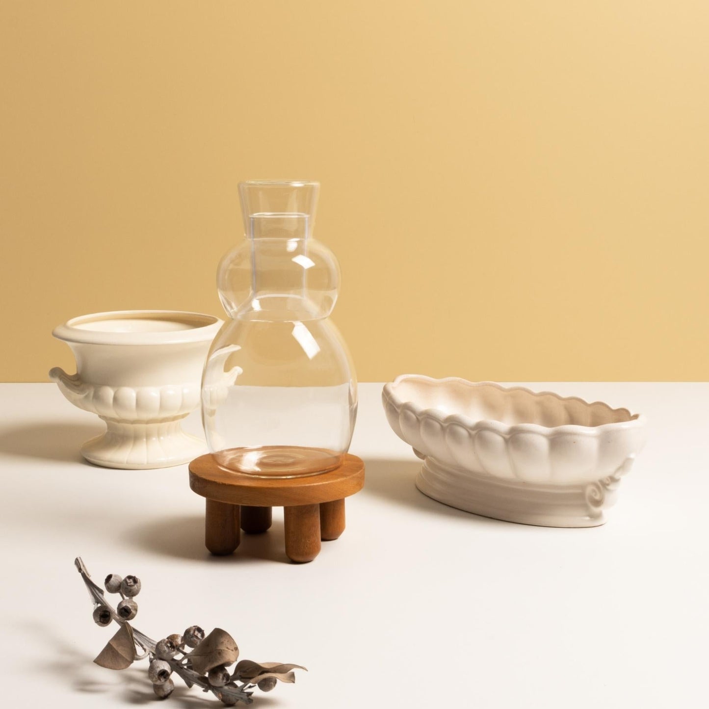 Coco and Henry clear Marnie carafe and stemless wine glass stacked with white scalloped porcelain vases